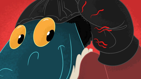 A happy Toestie the Dragon raises his gloved hand