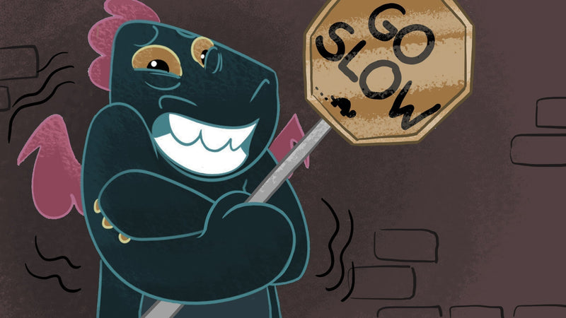 Toesty the Dragon shivers while holding a "Go Slow" traffic sign.