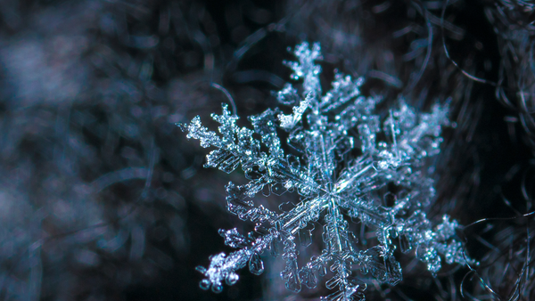 Close up of crystalline snowflake. Heat Holders® Thermal Outerwear. 
