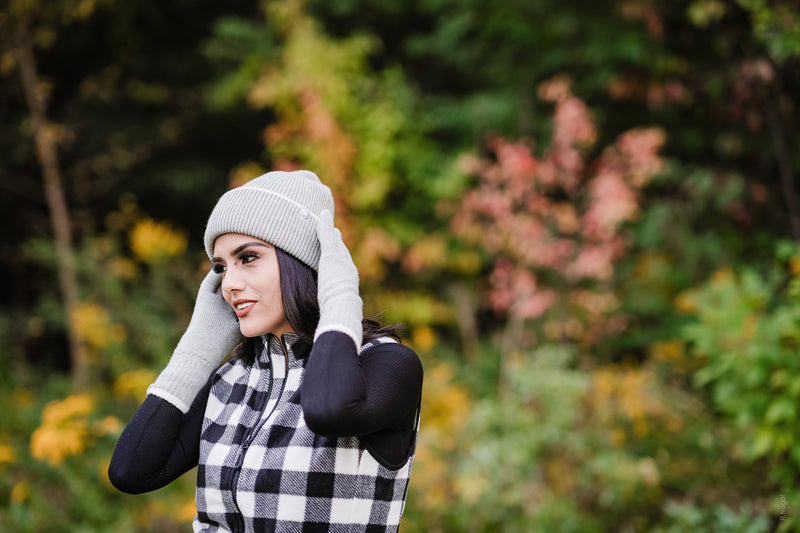 Women in a plaid Heat Holders® thermal vest adjusts her hat.