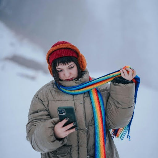 Woman in winter clothes holding a phone