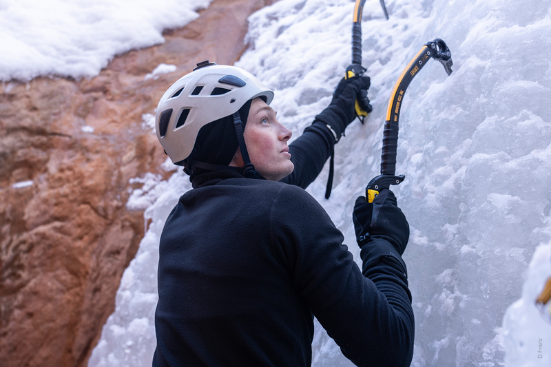 Man ice climbing up a mountain. | Heat Holders®