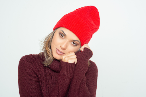 A woman with short hair wearing winter hat