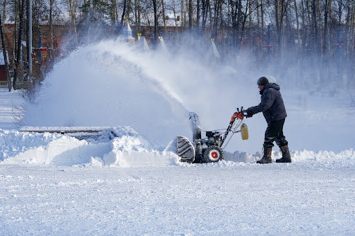 Man working with snow blower in winter. | Heat Holders®