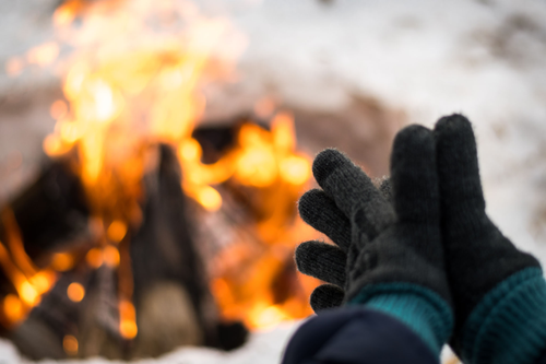 Heat Holders thermal gloves with fire in the background
